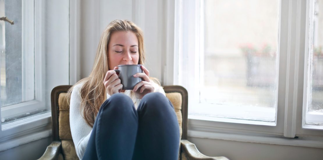Woman warm in house drinking from mug